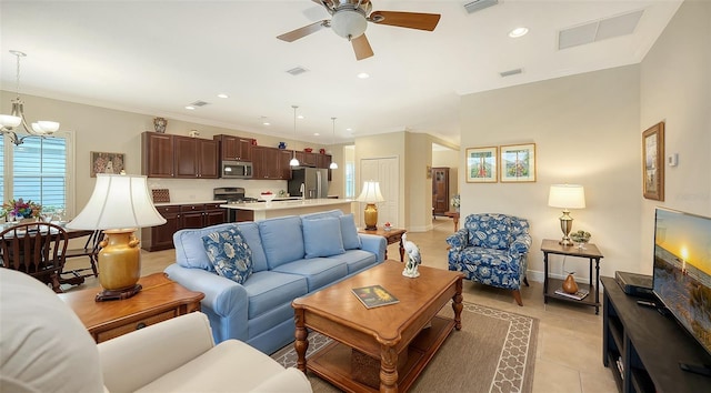 tiled living room featuring ceiling fan with notable chandelier and crown molding