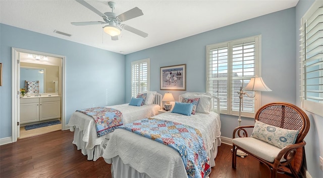 bedroom with ceiling fan, dark wood-type flooring, connected bathroom, and multiple windows