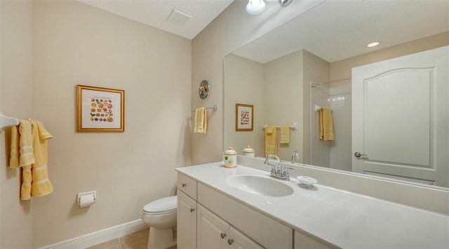 bathroom with tile patterned flooring, vanity, toilet, and walk in shower