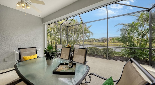 sunroom with a water view, plenty of natural light, and ceiling fan