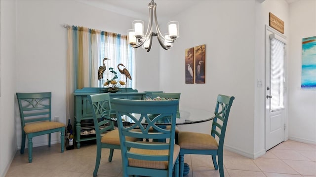 dining room with light tile patterned floors and a chandelier