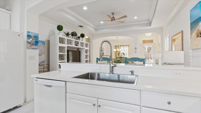 kitchen featuring white appliances, a tray ceiling, white cabinetry, and sink