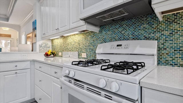 kitchen featuring white cabinets, custom exhaust hood, white range with gas stovetop, and tasteful backsplash