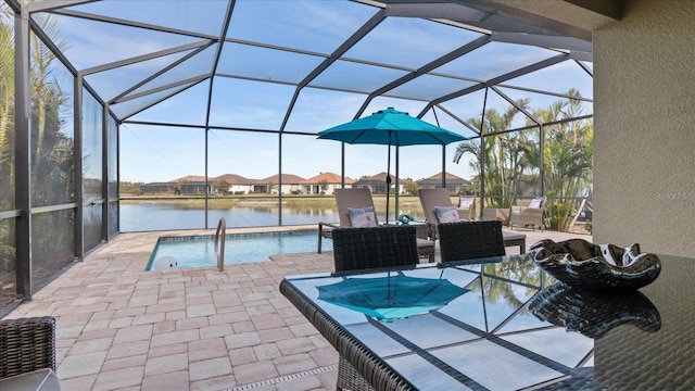 view of swimming pool with a lanai, a patio, and a water view