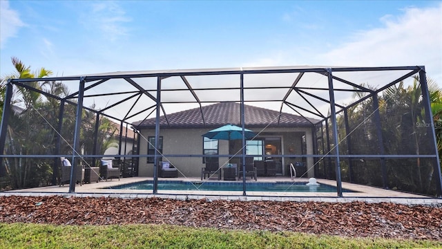 view of swimming pool featuring a lanai