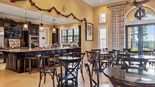 dining area featuring french doors, ceiling fan, and crown molding