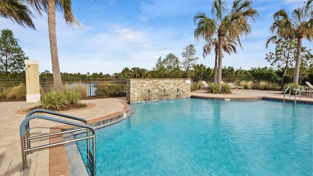 view of pool with pool water feature and a patio