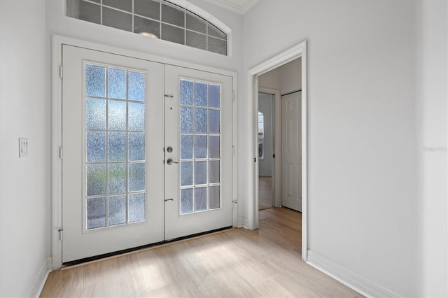 doorway to outside with light hardwood / wood-style floors and french doors