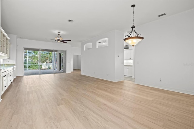 unfurnished living room with ceiling fan, sink, and light hardwood / wood-style floors