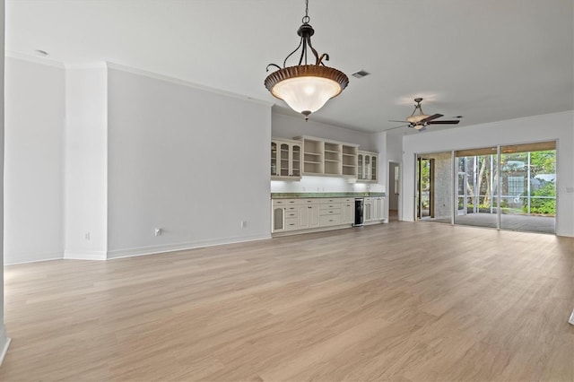 unfurnished living room featuring ceiling fan, light hardwood / wood-style floors, ornamental molding, and beverage cooler