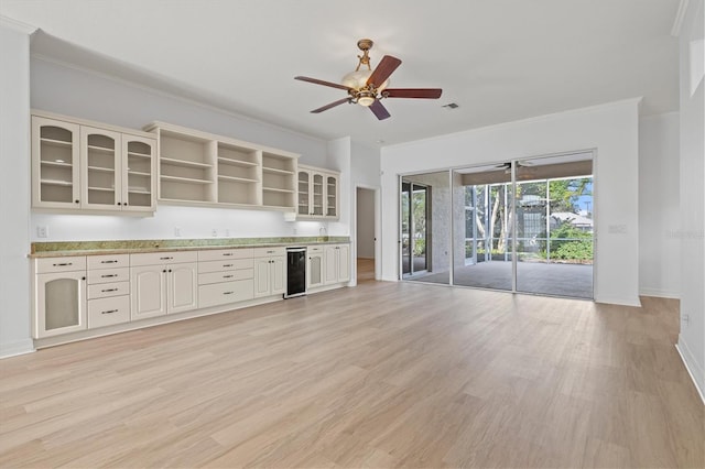 kitchen featuring wine cooler, ceiling fan, ornamental molding, and light wood-type flooring