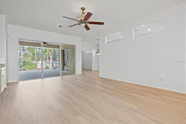 unfurnished living room featuring ornamental molding and light hardwood / wood-style flooring