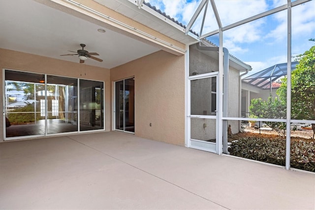 unfurnished sunroom with a wealth of natural light and ceiling fan