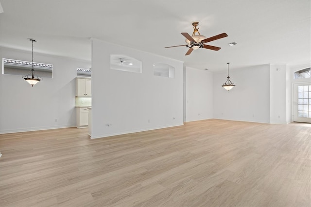 unfurnished living room featuring ceiling fan and light hardwood / wood-style floors