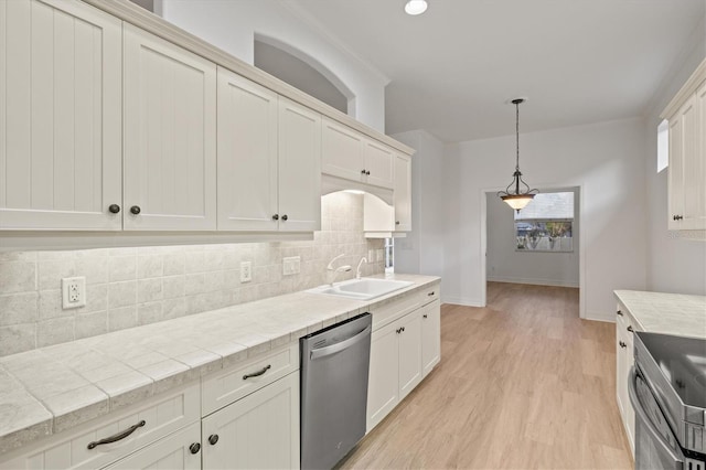 kitchen featuring sink, tasteful backsplash, stainless steel dishwasher, tile countertops, and range