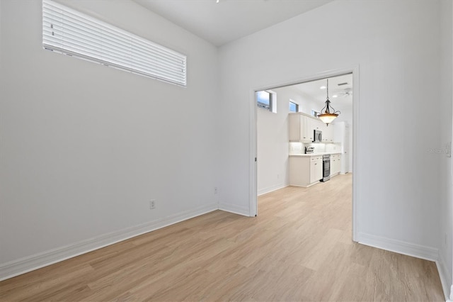 unfurnished room with light wood-type flooring