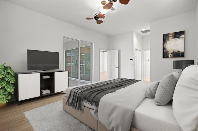 bedroom featuring ceiling fan, access to exterior, and light hardwood / wood-style flooring