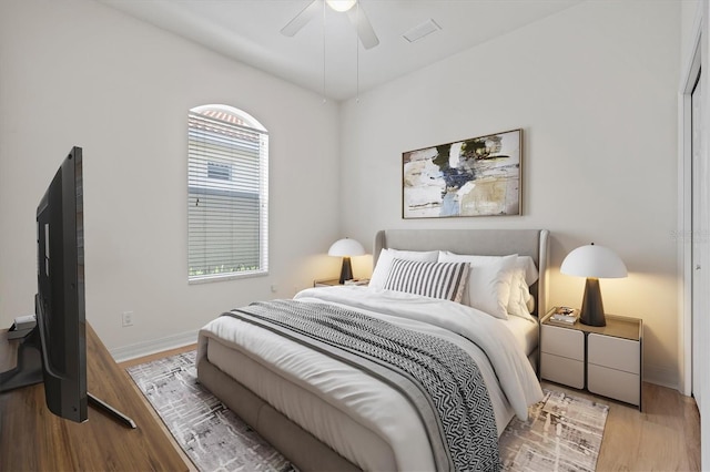 bedroom with ceiling fan and light hardwood / wood-style floors