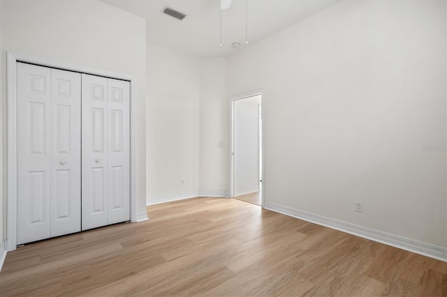 unfurnished bedroom with a closet and light hardwood / wood-style flooring