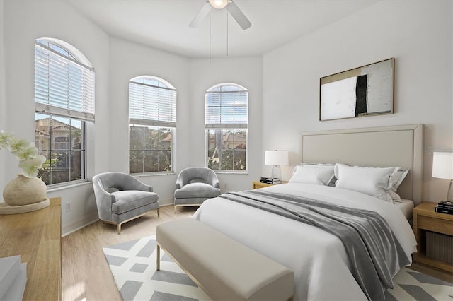 bedroom with ceiling fan and light hardwood / wood-style floors