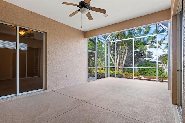 unfurnished sunroom with ceiling fan