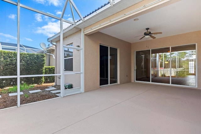 unfurnished sunroom featuring ceiling fan