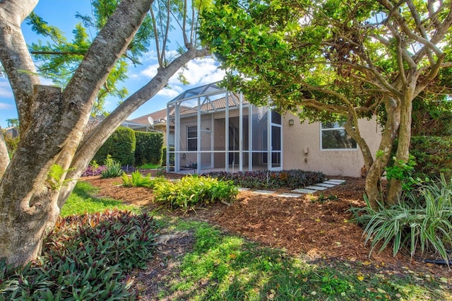 rear view of house featuring a lanai