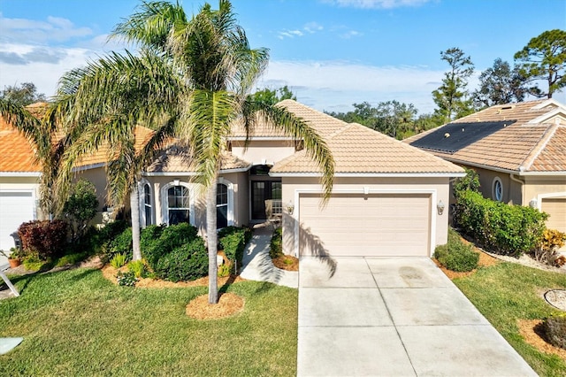 view of front of home featuring a garage and a front lawn