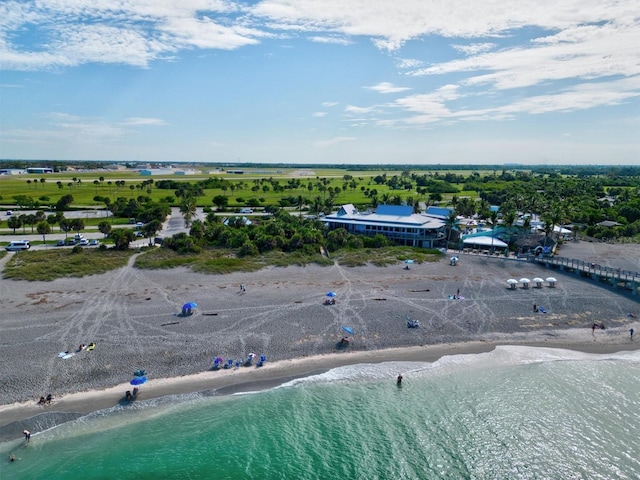 drone / aerial view featuring a water view and a beach view