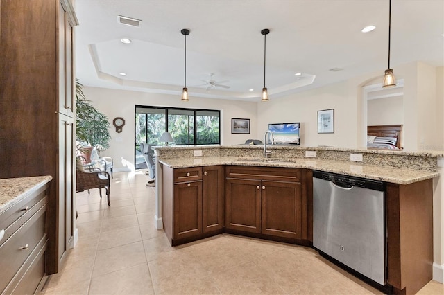 kitchen featuring stainless steel dishwasher, a raised ceiling, ceiling fan, sink, and decorative light fixtures