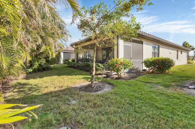 view of yard featuring a sunroom