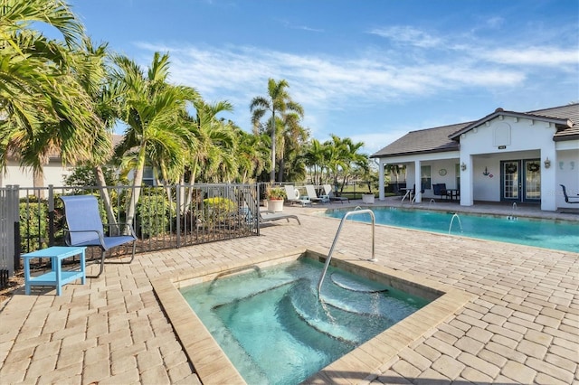 view of swimming pool featuring a patio area and a community hot tub