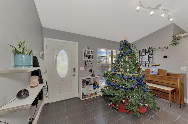 tiled entrance foyer featuring lofted ceiling