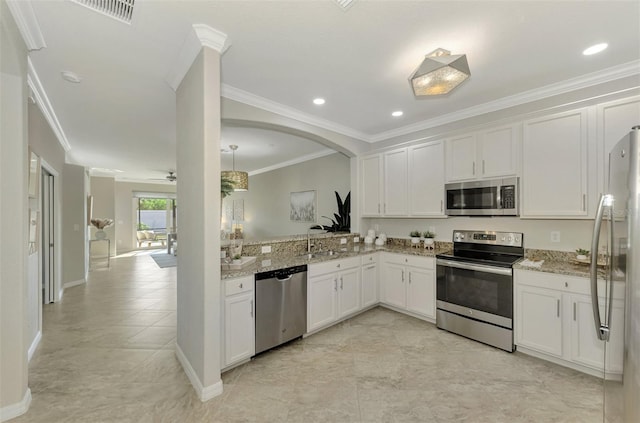 kitchen featuring white cabinetry, sink, light stone countertops, appliances with stainless steel finishes, and ornamental molding