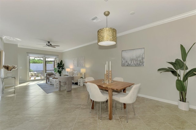 dining area featuring ceiling fan and ornamental molding