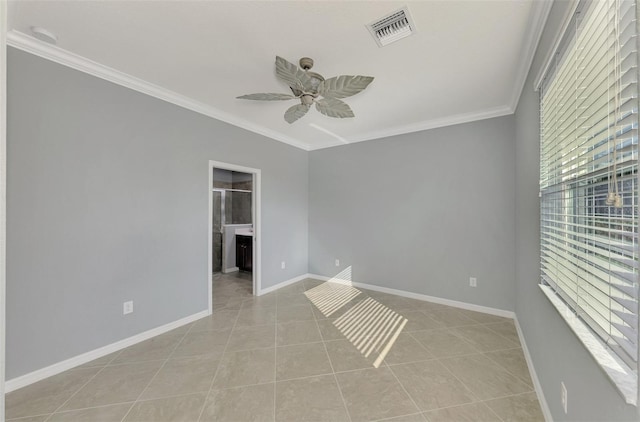 spare room with ceiling fan, light tile patterned floors, and ornamental molding