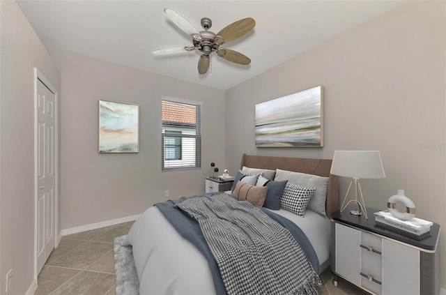 tiled bedroom featuring ceiling fan