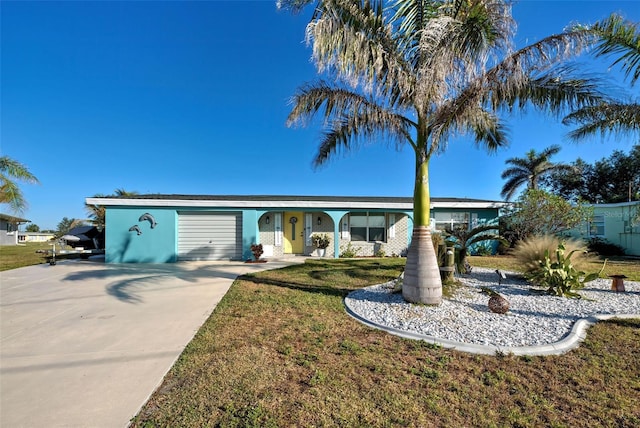 ranch-style house with a garage and a front lawn