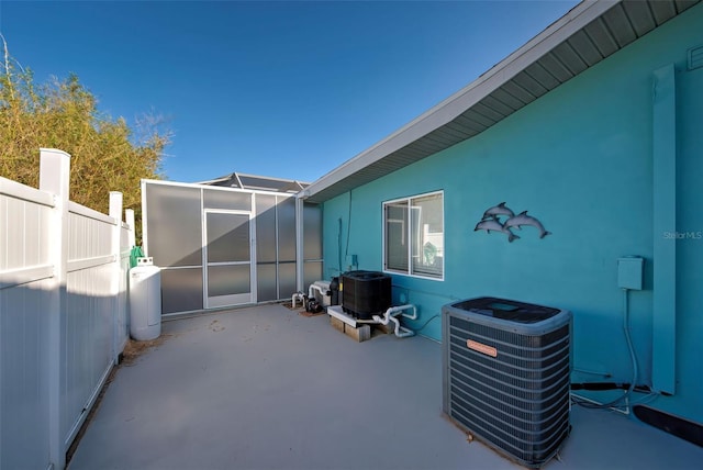 view of patio featuring a lanai and central air condition unit