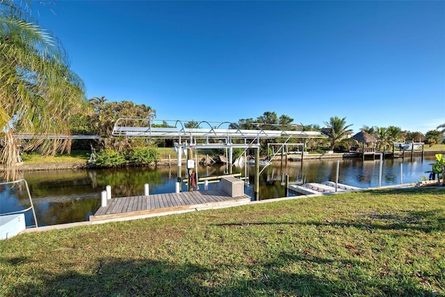 dock area with a yard and a water view