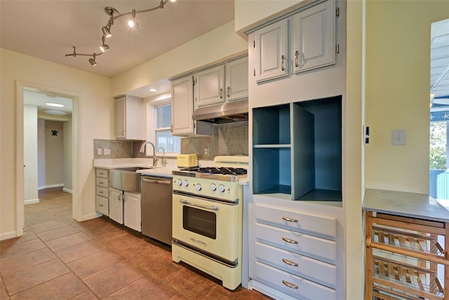 kitchen with gray cabinetry, sink, white range with gas stovetop, stainless steel dishwasher, and backsplash