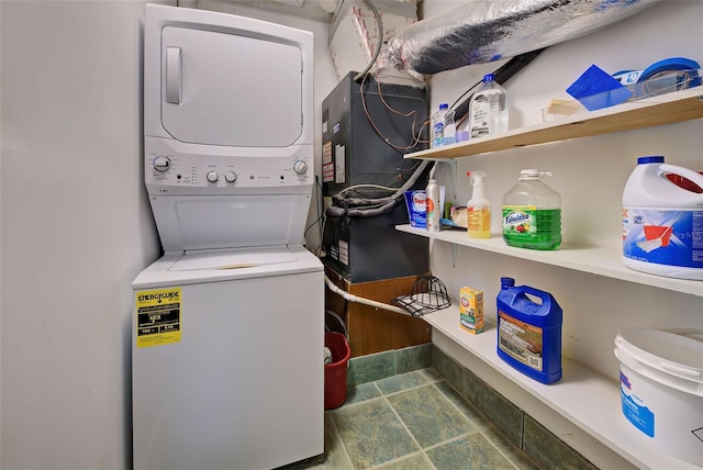 laundry area featuring stacked washing maching and dryer