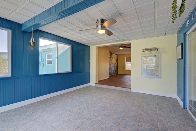 unfurnished room featuring tile patterned floors and ceiling fan