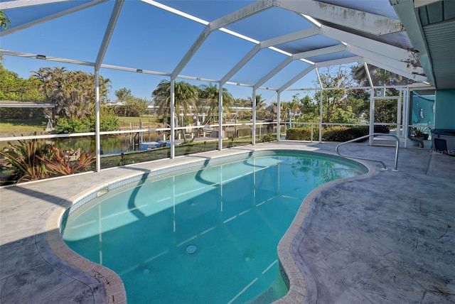 view of swimming pool with glass enclosure, a patio area, and a water view