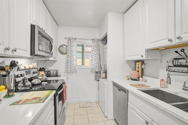 kitchen featuring white cabinets, light tile patterned floors, stainless steel appliances, and sink