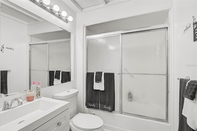 full bathroom featuring vanity, bath / shower combo with glass door, and toilet