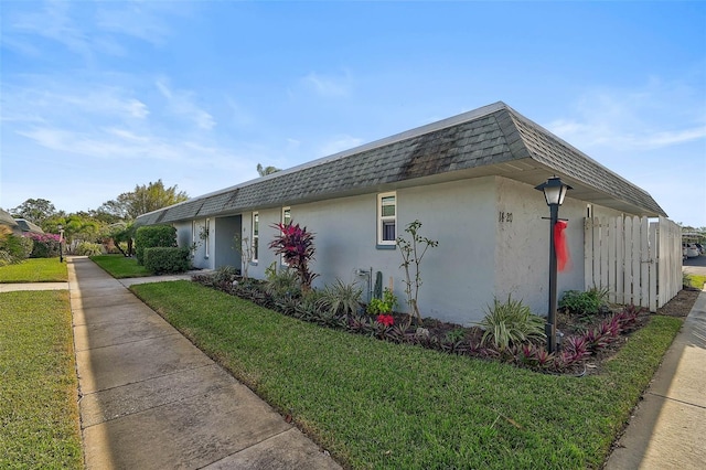 view of property exterior featuring a lawn