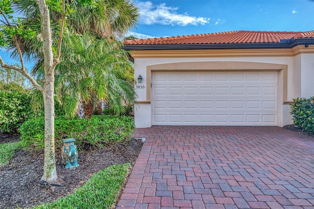 garage featuring decorative driveway