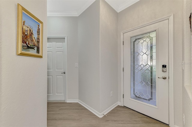 entryway with crown molding and light hardwood / wood-style flooring