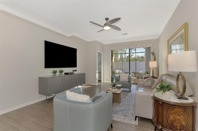 living room featuring ceiling fan, light wood-type flooring, and ornamental molding